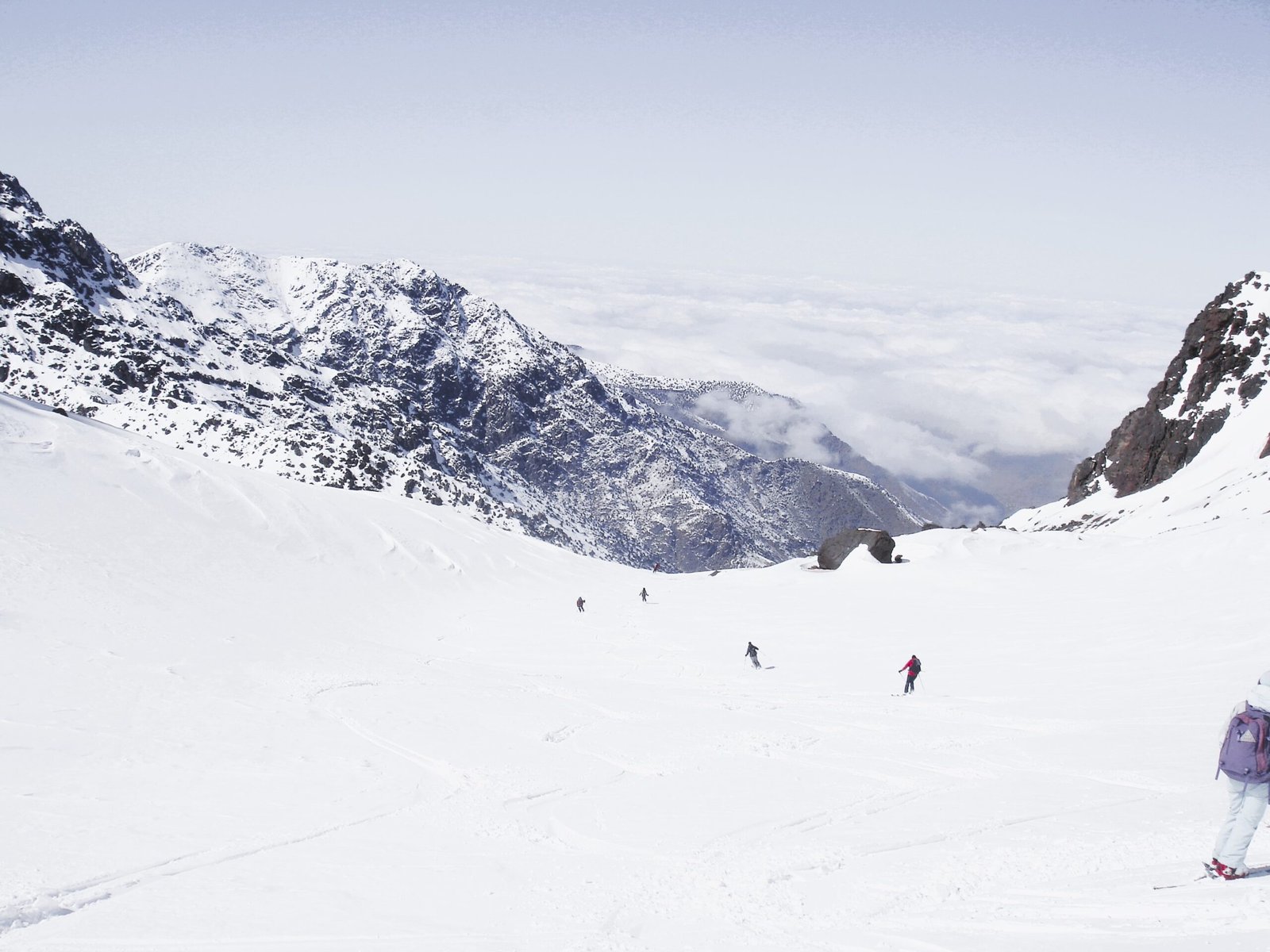 a group of people skiing down a mountain